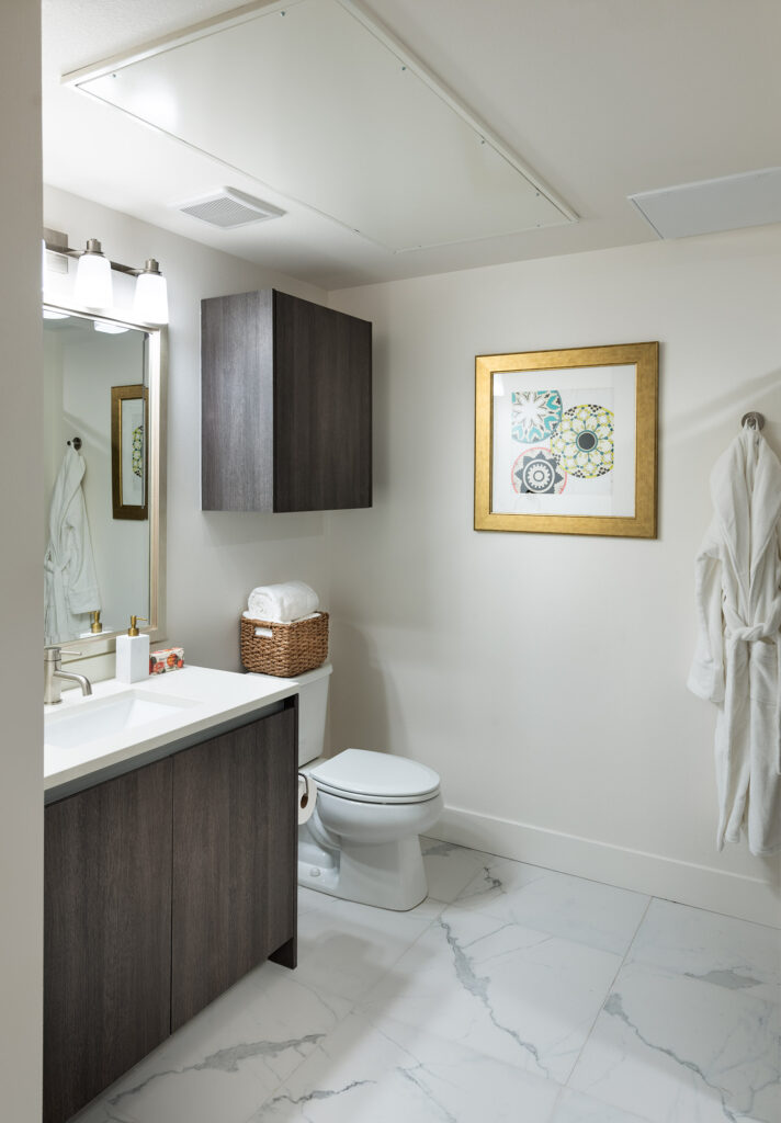 Bathroom with quartz counters, sink, and designer lighting