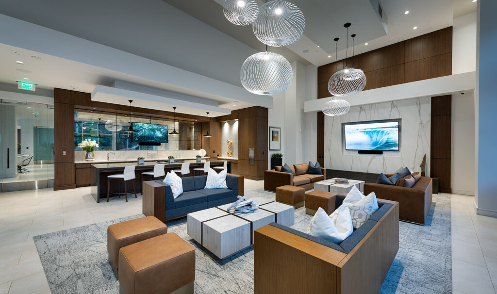 Clubhouse with modern furniture, kitchen area and flat screen TVs