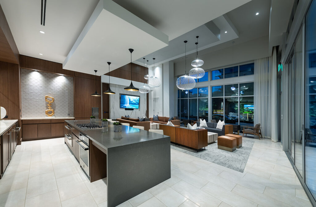 Club kitchen area with stove, oven, designer lighting and seating