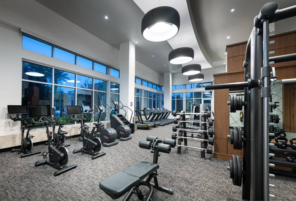 Fitness Center with variety of cardio machines, strength training equipment, lots of light, and large windows