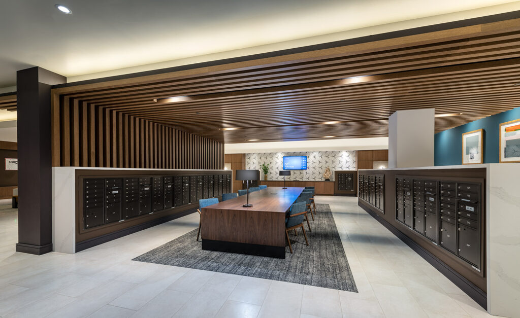 Mail room with large conference table and rows of mailboxes