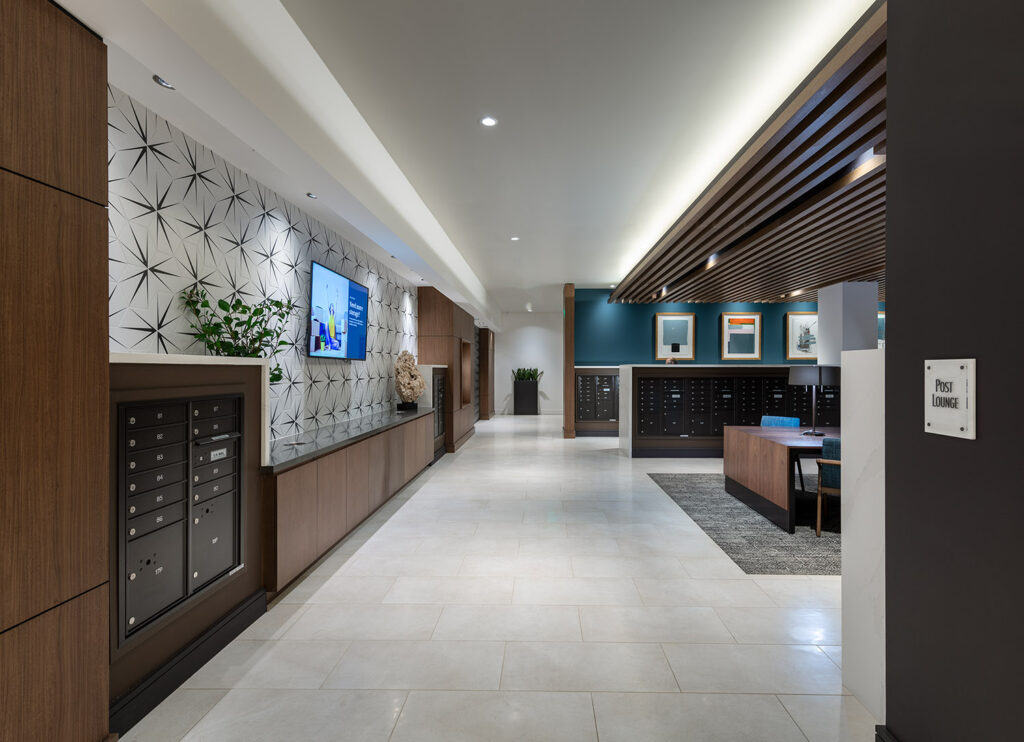 Mail room with sections of mailboxes, flat screen TV and seating