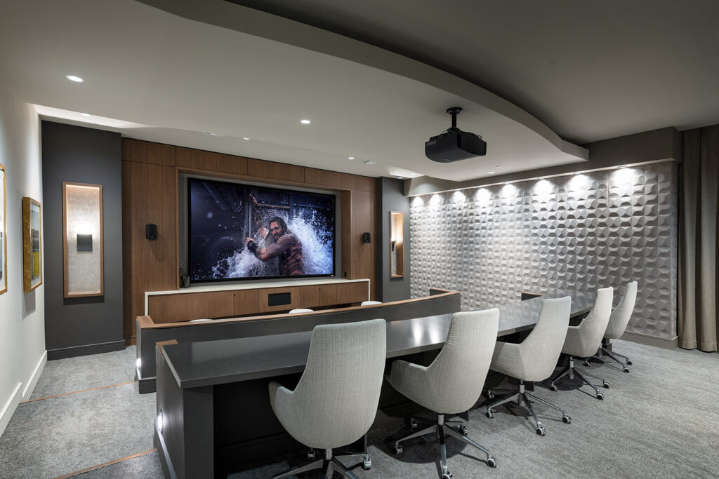 Media room with theater style seating and large movie screen